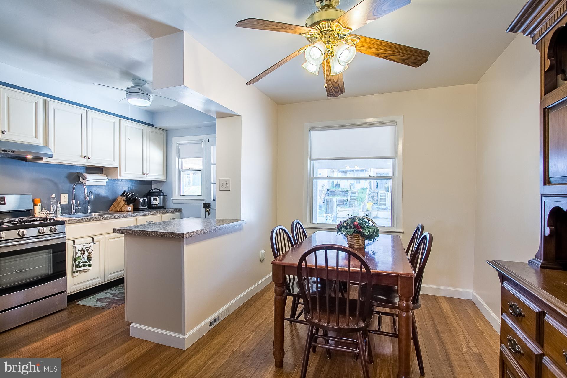 4444 Fenor Road Baltimore, MD 21227 - Photo 5 of 26 a dining room with furniture a chandelier and wooden floor