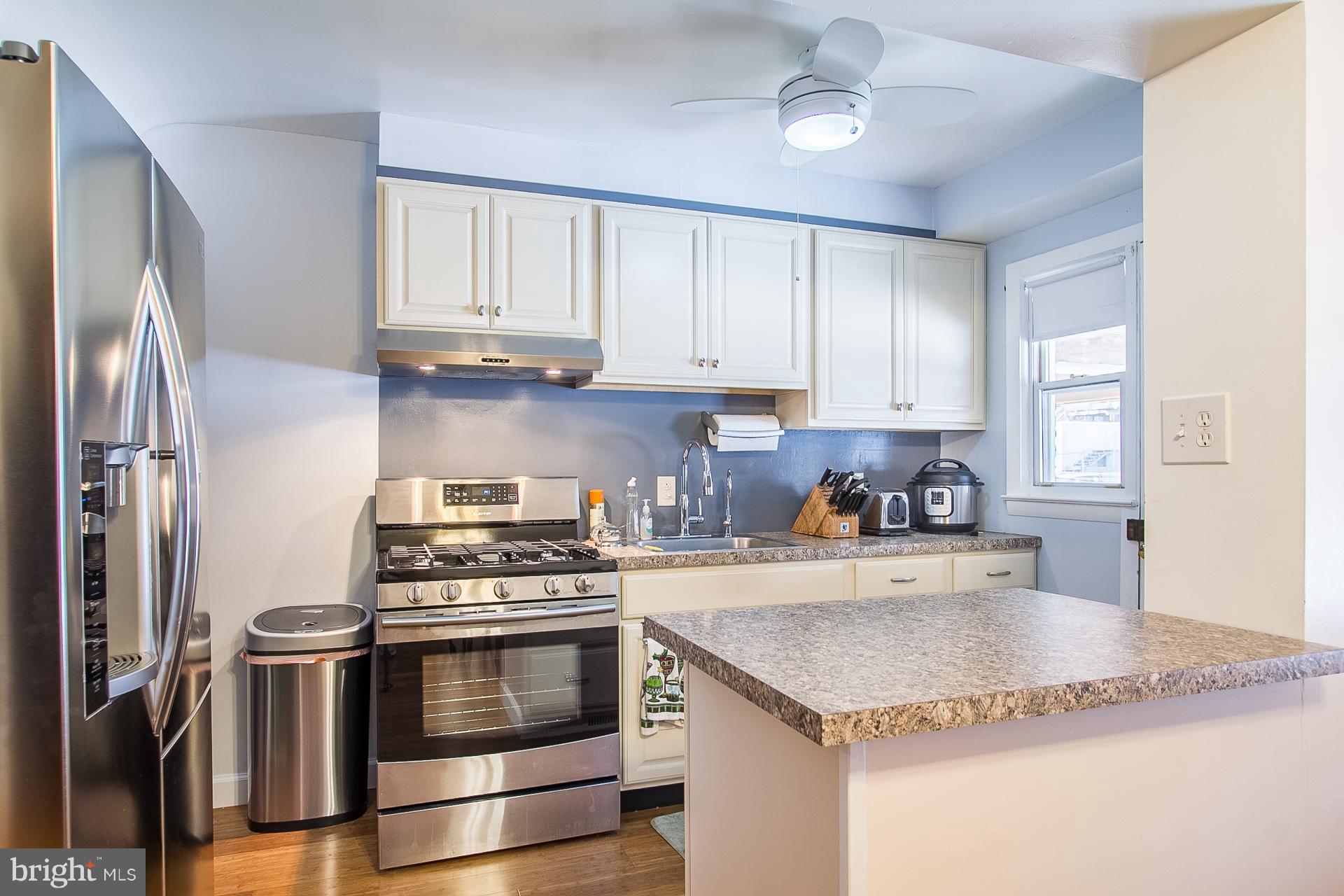 4444 Fenor Road Baltimore, MD 21227 - Photo 7 of 26 a kitchen with stainless steel appliances granite countertop a stove a refrigerator and a sink