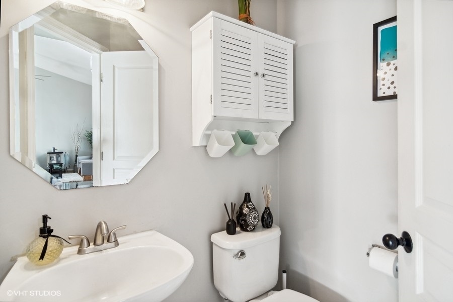 440 Spaulding Road Bartlett, IL 60103 - Photo 22 of 27 a bathroom with a sink a toilet and mirror