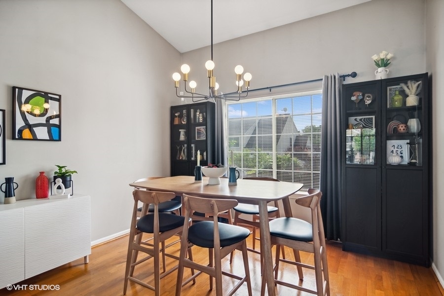 440 Spaulding Road Bartlett, IL 60103 - Photo 5 of 27 a view of a dining room with furniture wooden floor and a chandelier