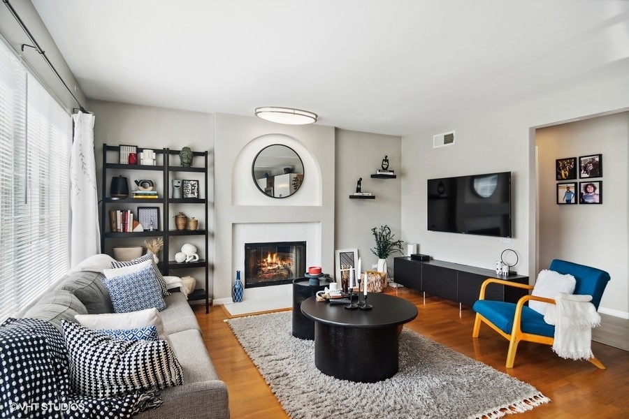 440 Spaulding Road Bartlett, IL 60103 - Photo 9 of 27 a living room with furniture a rug and a fireplace