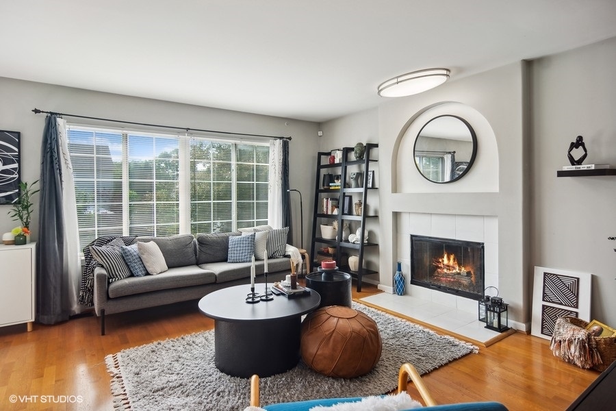 440 Spaulding Road Bartlett, IL 60103 - Photo 10 of 27 a living room with furniture a fireplace and a floor to ceiling window