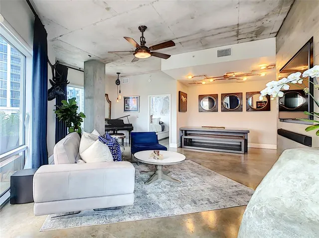 a living room with furniture and a flat screen tv
