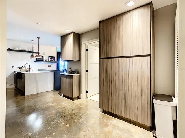 a kitchen with a sink a refrigerator and trees