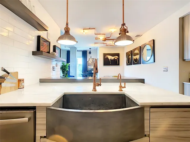 a kitchen with stainless steel appliances a sink a stove and a refrigerator