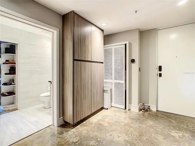 an empty room with closet and windows