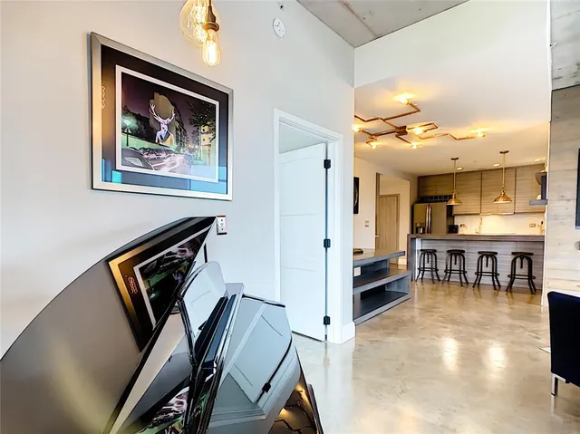 a view of living room with furniture and a lamp
