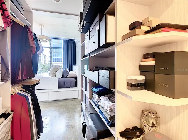 a bedroom with furniture and a large window