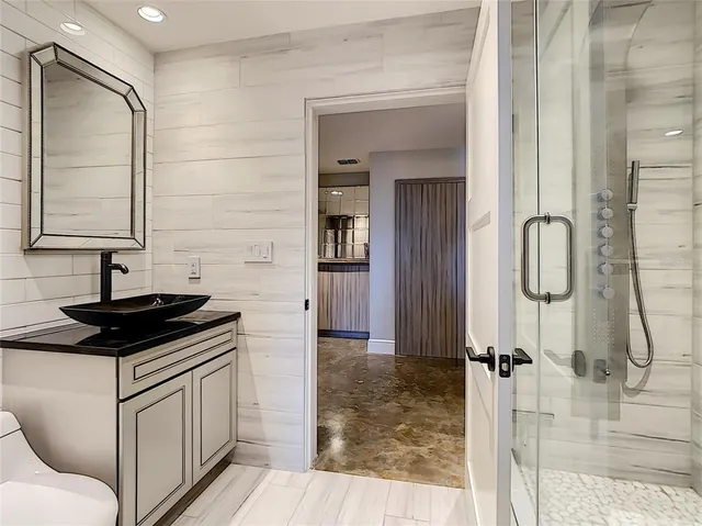 a bedroom with bed and a large window