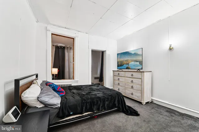 a bedroom with a bed and a dresser