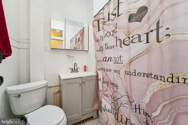a bathroom with a toilet sink and mirror