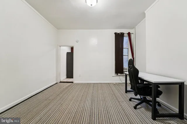 a view of a room with gym equipment and wooden floor
