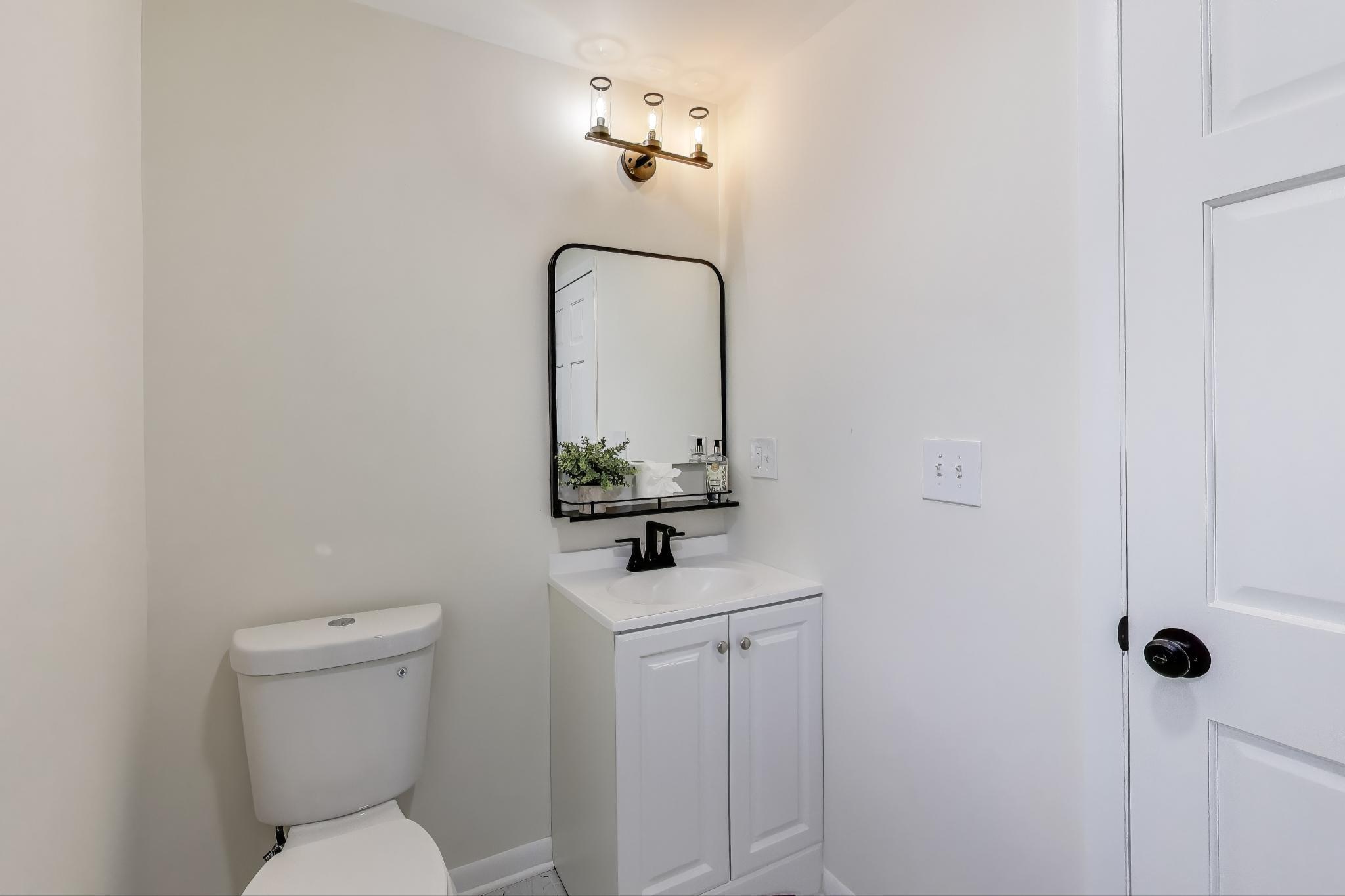 102 South Karwick Road Michigan City, IN 46360 - Photo 15 of 30 a bathroom with a toilet sink and mirror