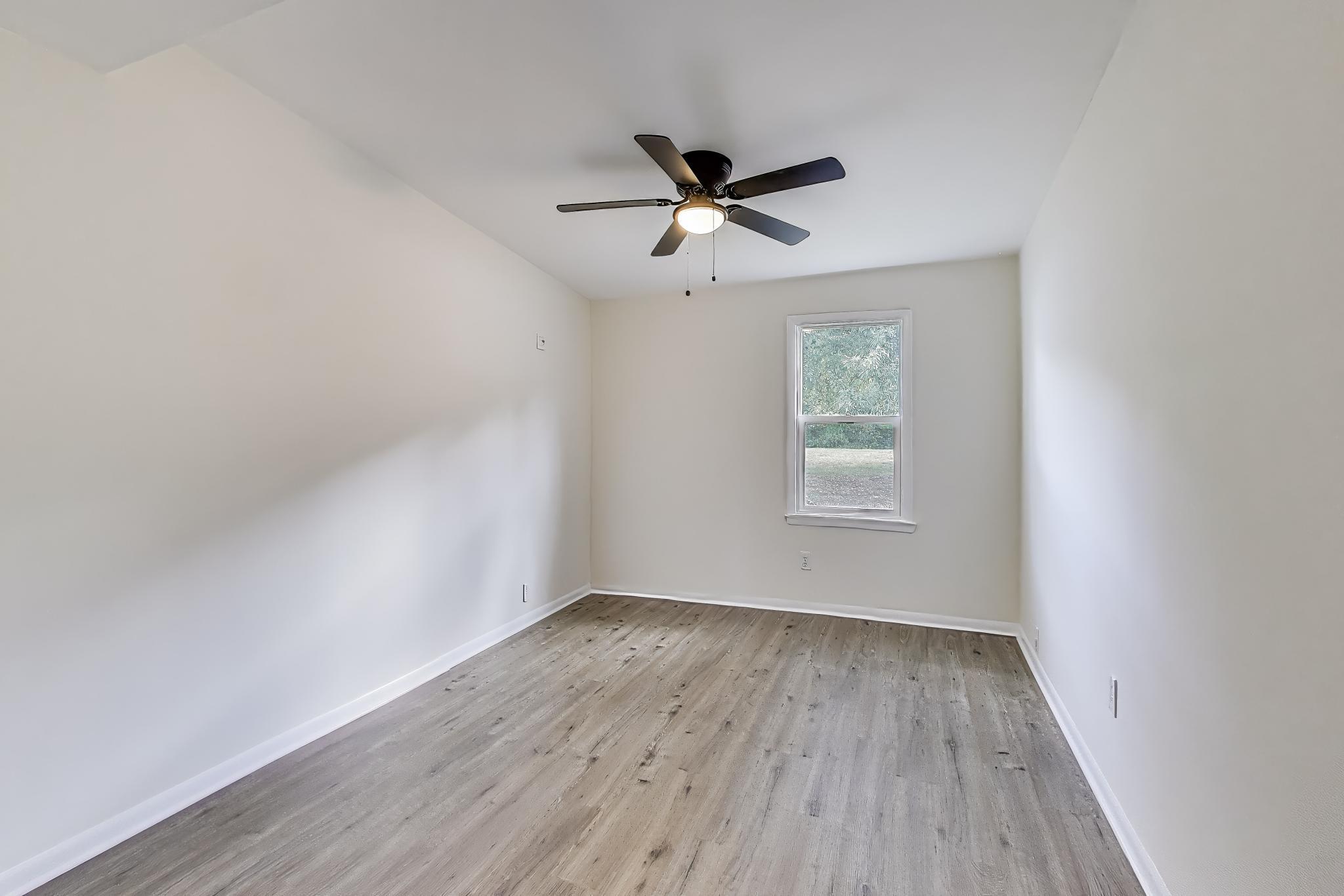 102 South Karwick Road Michigan City, IN 46360 - Photo 17 of 30 a view of empty room with wooden floor and fan