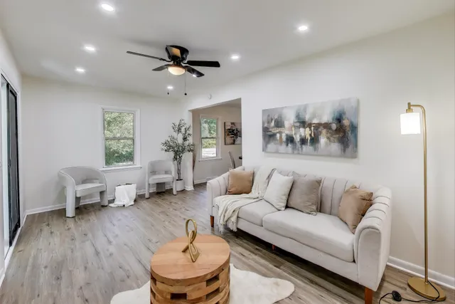 a living room with furniture and wooden floor