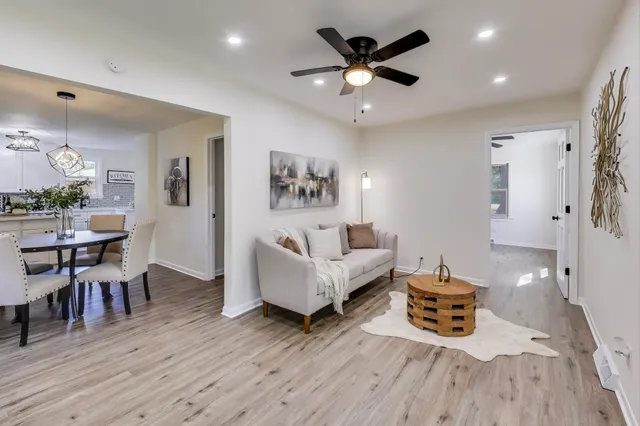 a living room with furniture and wooden floor
