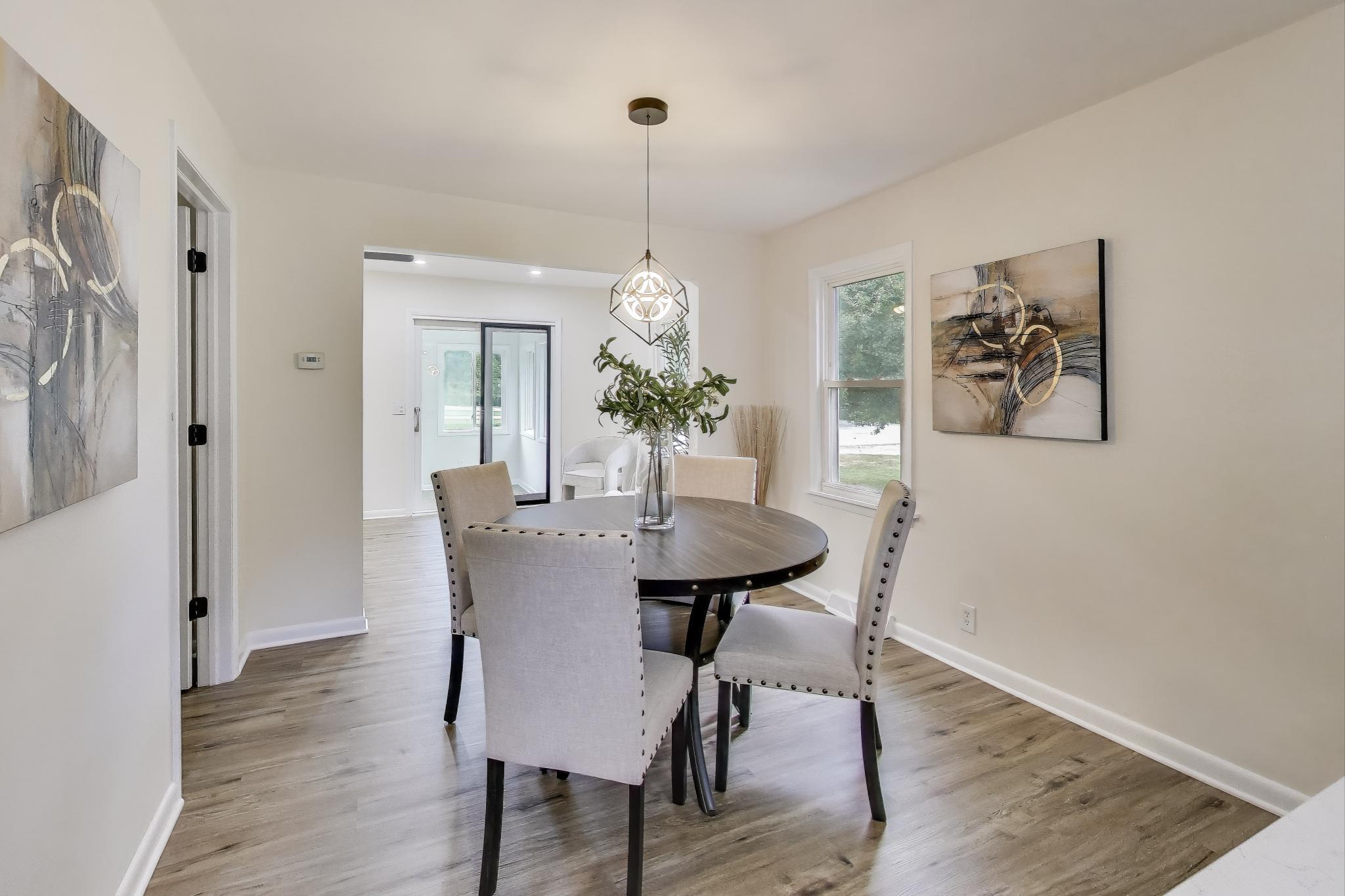 102 South Karwick Road Michigan City, IN 46360 - Photo 6 of 30 a dining room with furniture potted plants and wooden floor