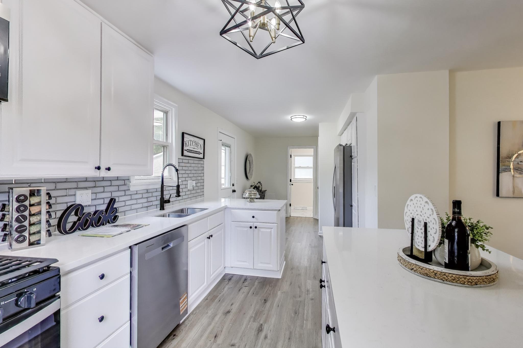 102 South Karwick Road Michigan City, IN 46360 - Photo 8 of 30 a kitchen with a sink and cabinets
