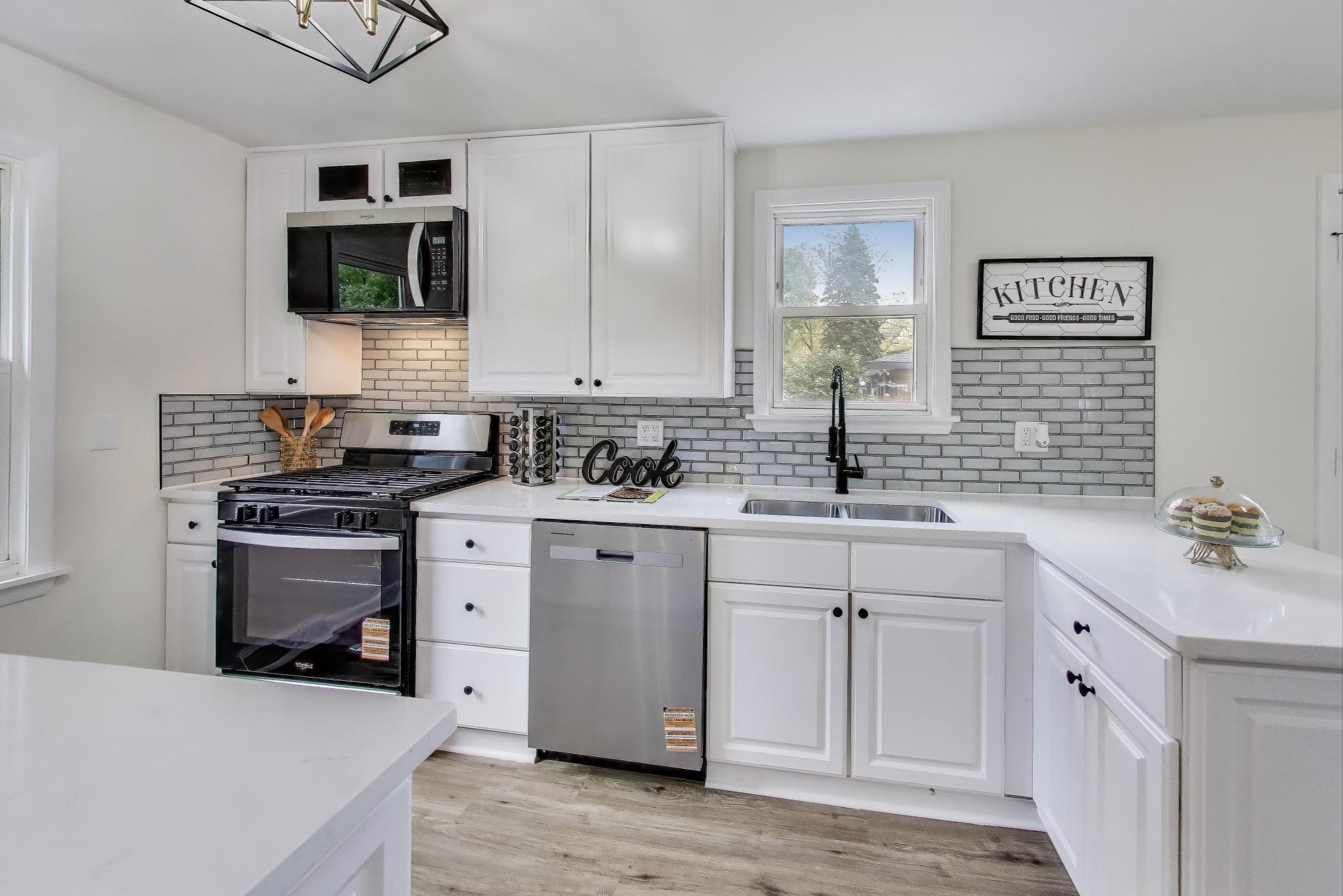 102 South Karwick Road Michigan City, IN 46360 - Photo 10 of 30 a kitchen with cabinets stainless steel appliances and a sink