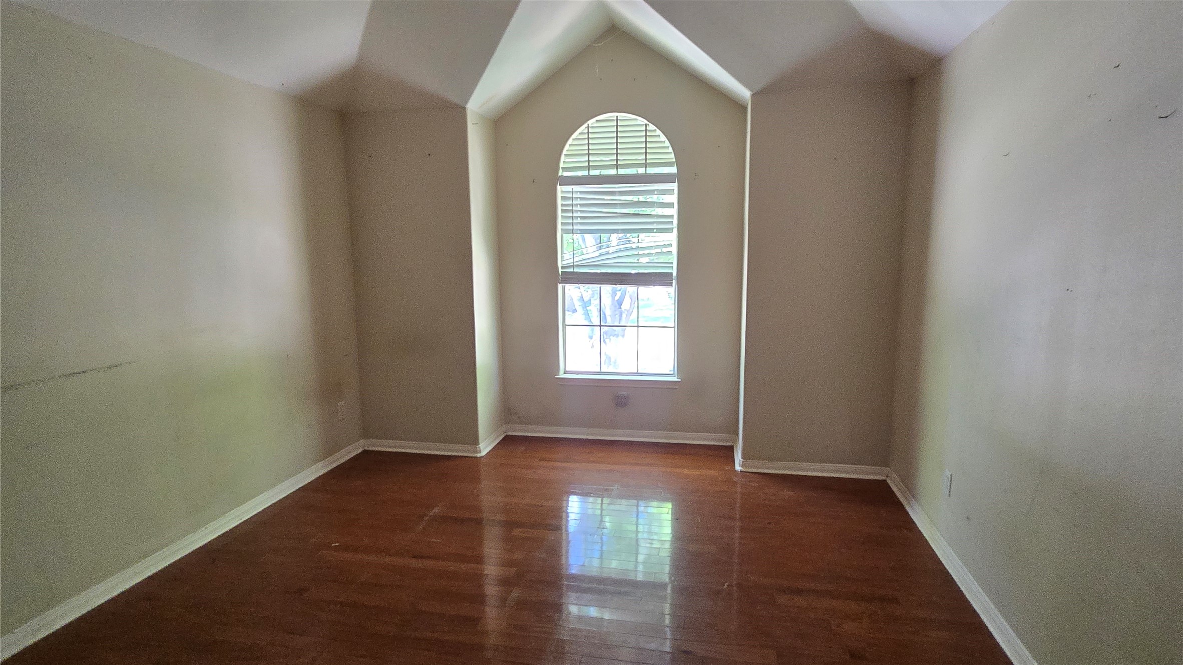 131 Annes Way Stafford, TX 77477 - Photo 19 of 25 wooden floor in an empty room with a window