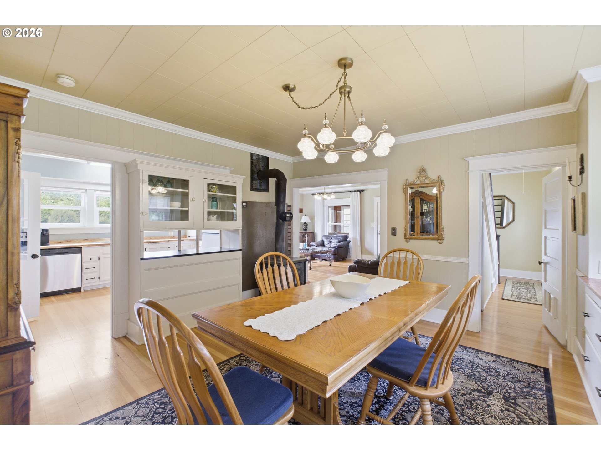 2862 Matheny Road Northeast Gervais, OR 97026 - Photo 12 of 47 a dining room with wooden floor a chandelier a wooden table and chairs