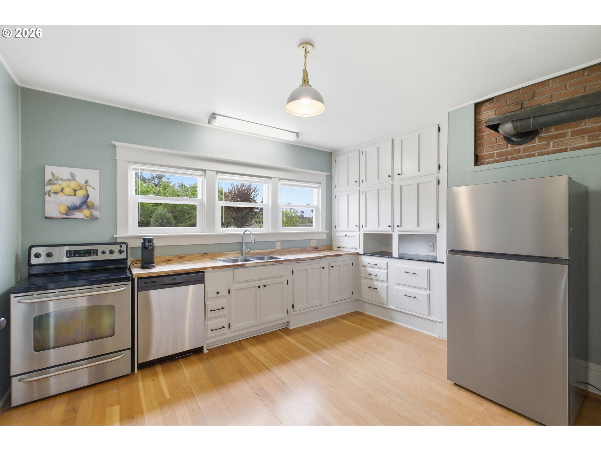 2862 Matheny Road Northeast Gervais, OR 97026 - Photo 13 of 47 a kitchen with stainless steel appliances granite countertop a refrigerator a stove a sink and a microwave