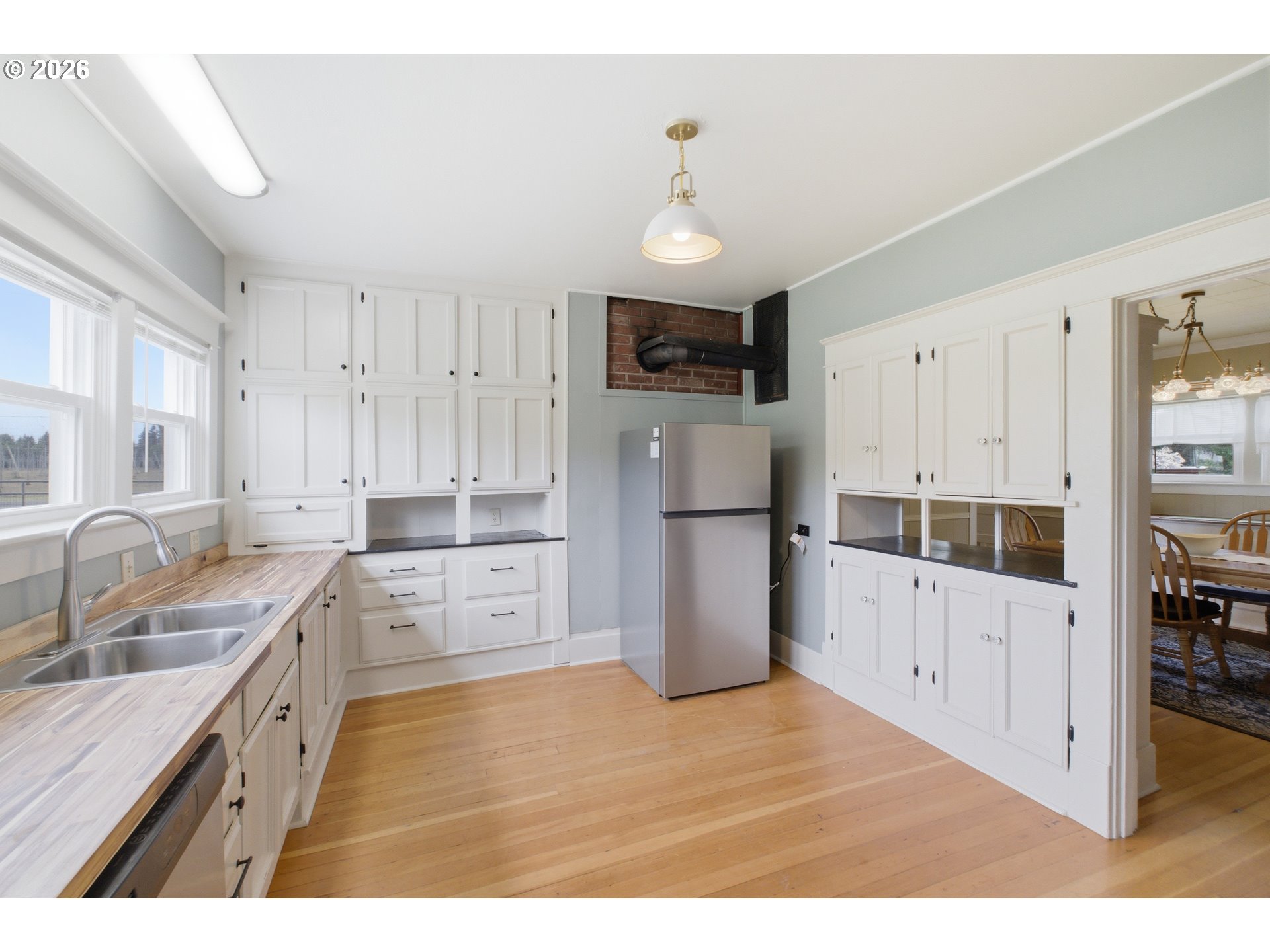 2862 Matheny Road Northeast Gervais, OR 97026 - Photo 14 of 47 a kitchen with white cabinets and stainless steel appliances