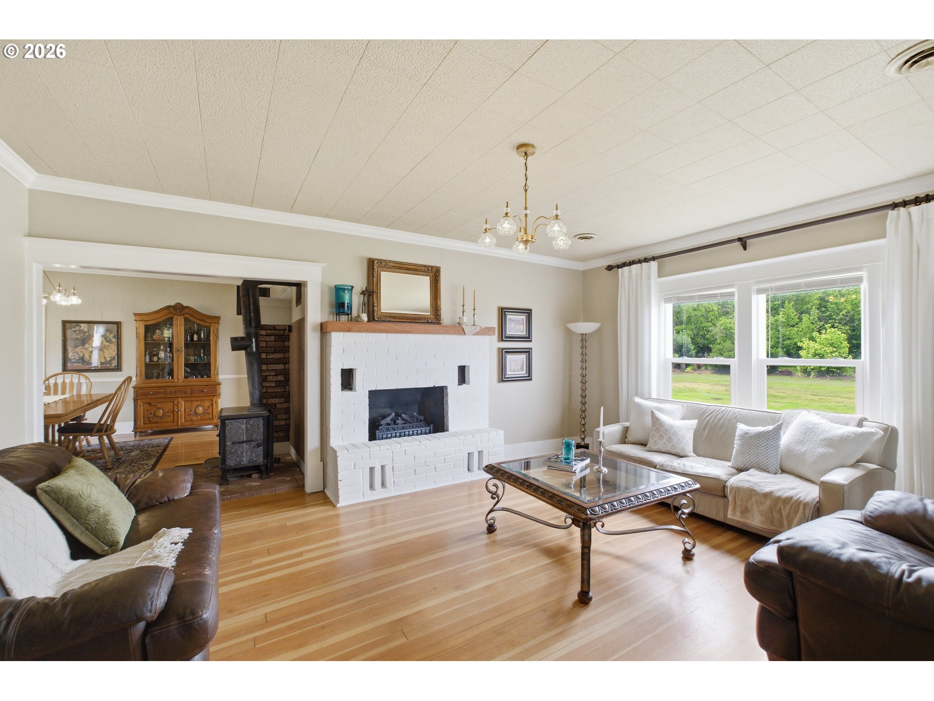 2862 Matheny Road Northeast Gervais, OR 97026 - Photo 6 of 47 a living room with furniture a fireplace and a large window
