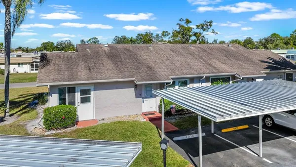 an outdoor view of the house with swimming pool