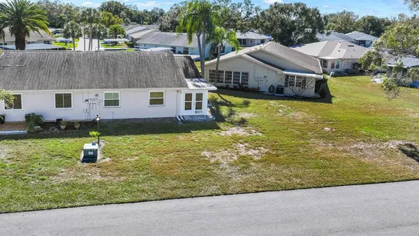 a aerial view of a house with a yard