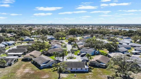 an aerial view of a residential houses with outdoor space