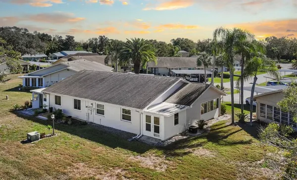 a view of a house with swimming pool next to a yard