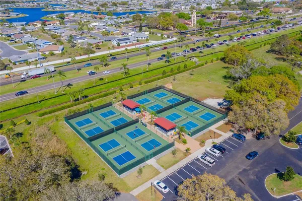 an aerial view of residential houses with outdoor space and swimming pool