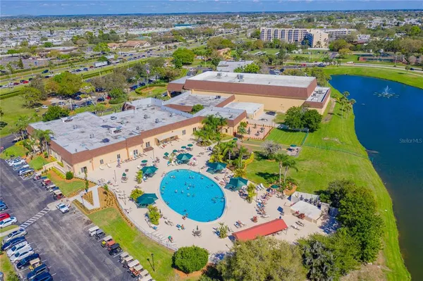 an aerial view of a house with a swimming pool yard and outdoor seating