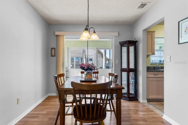 a dining room with furniture window and wooden floor