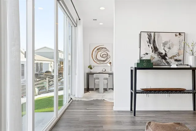 a view of a hallway with wooden floor