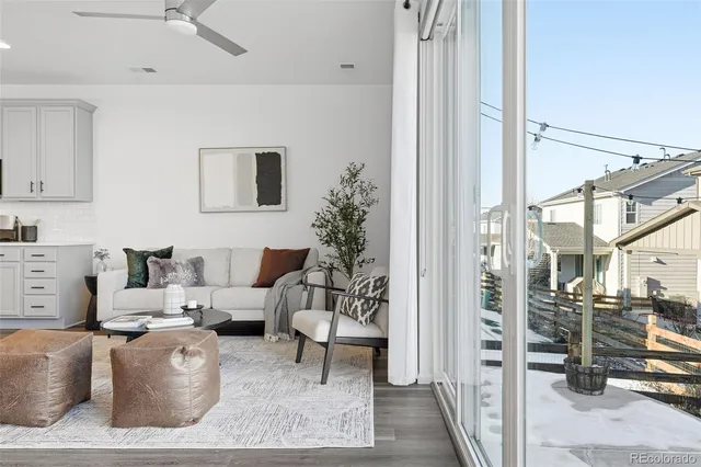 a living room with furniture a rug and a chandelier