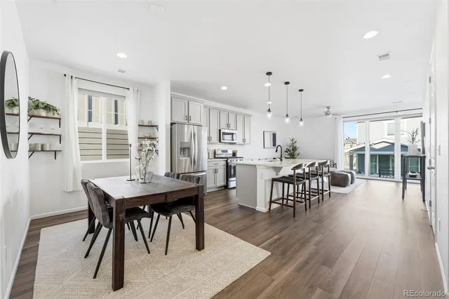 a view of a a dining room with furniture window and wooden floor