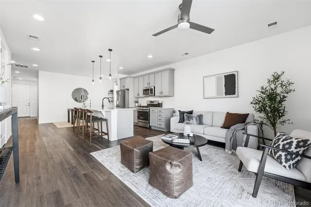 a living room with furniture and kitchen view