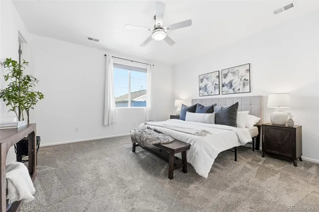 a spacious bedroom with a bed and a window