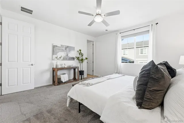 a spacious bedroom with a bed and a table