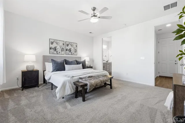 a spacious bedroom with a bed and a chandelier