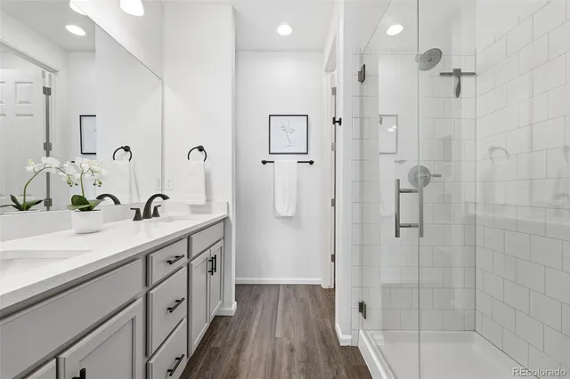 a spacious bathroom with a shower sink and mirror