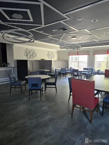 a view of a big room with dining room wooden floor and a rug