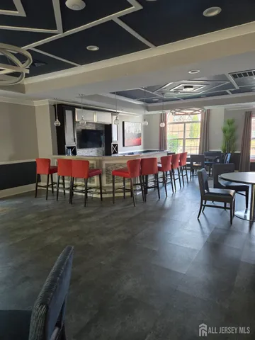 a living room with lots of furniture a chandelier