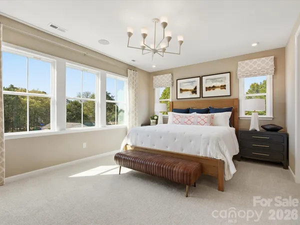a spacious bedroom with a bed and a large window