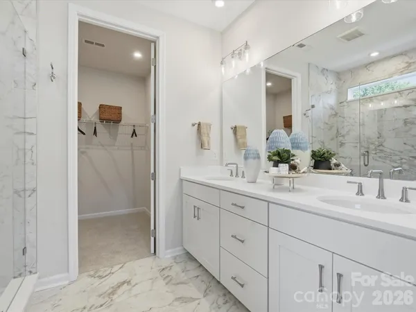 a bathroom with a shower sink and mirror