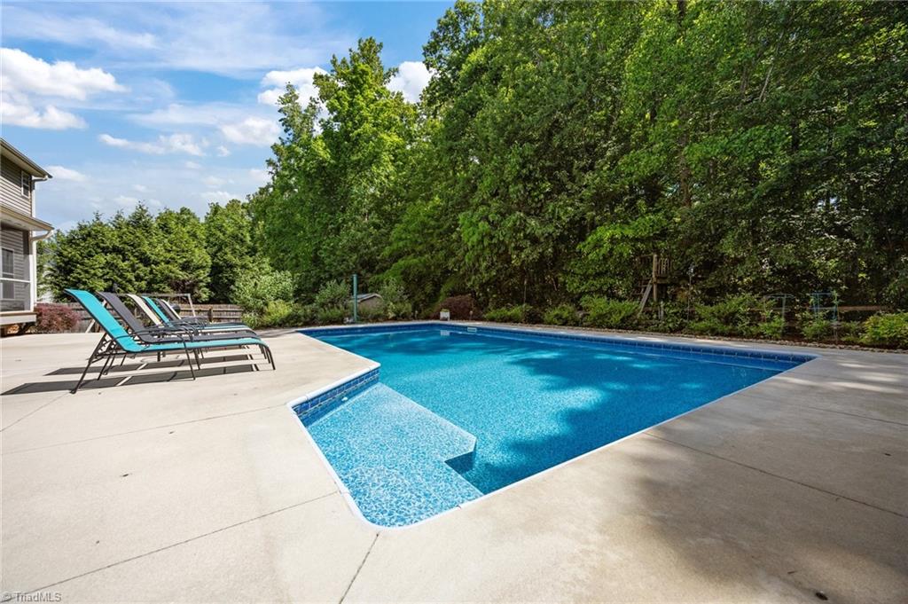 7812 Wilson Farm Road Summerfield, NC 27358 - Photo 2 of 50 Saltwater heated pool with color changing LED lights
