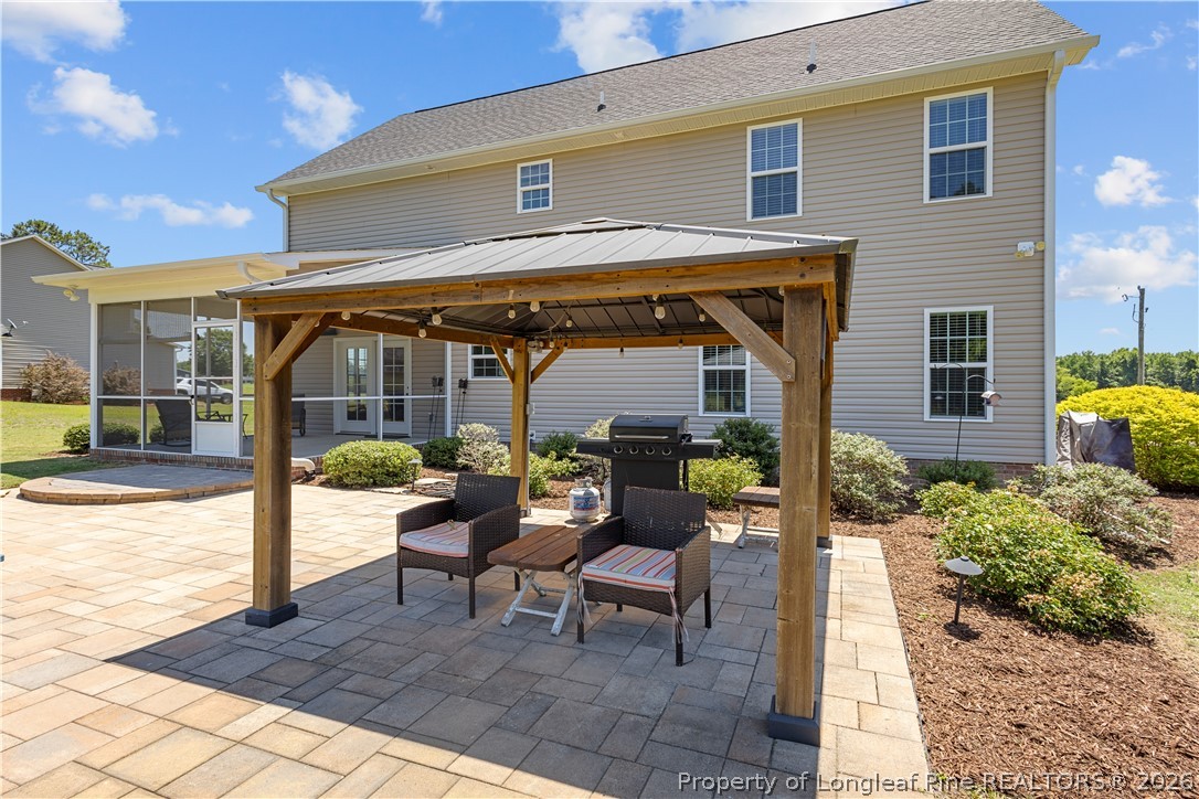 137 Minter School Road Sanford, NC 27332 - Photo 5 of 50 a view of a patio with table and chairs and potted plants