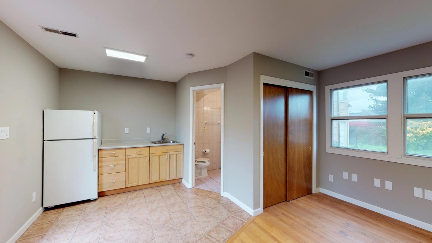 320 Cedar Street Millbrae, CA 94030 - Photo 28 of 33 a view of a kitchen with a refrigerator cabinet and a refrigerator
